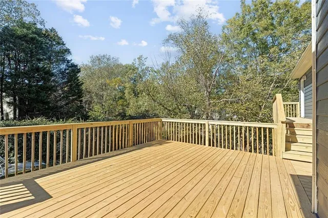 a balcony with wooden floor and fence