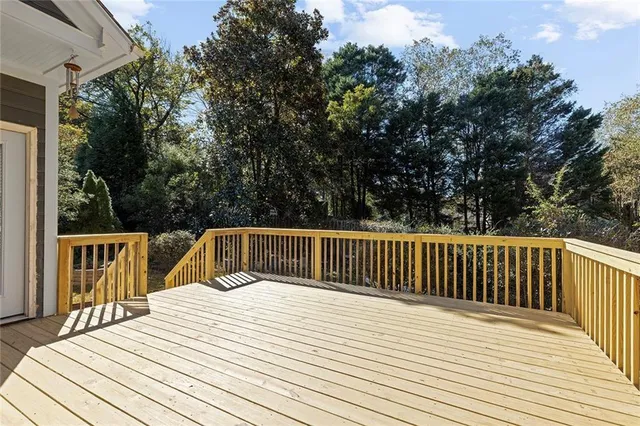 a balcony with wooden floor and fence
