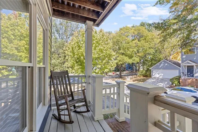 a view of balcony with chairs and wooden floor