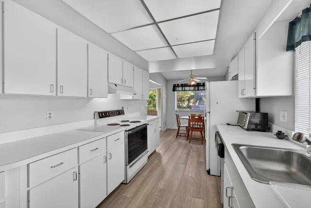 a kitchen with a sink stove and cabinets