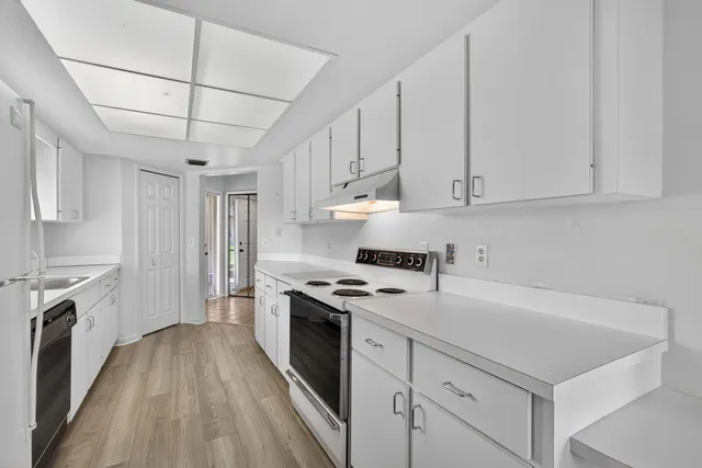 a view of a dining room with furniture large windows and wooden floor