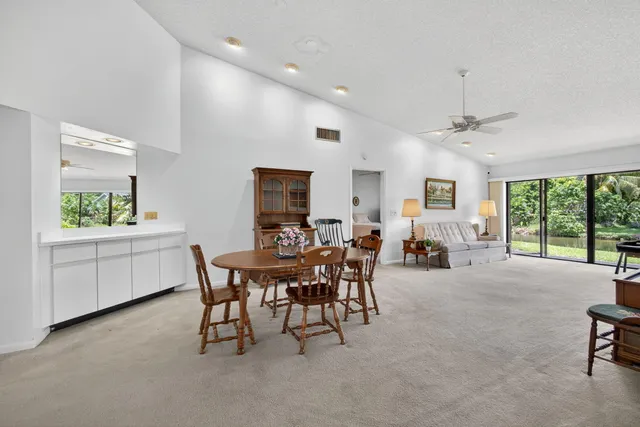 a view of a dining room and livingroom with furniture window and outside view