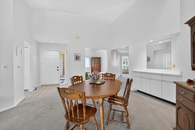 a view of a livingroom with furniture and a dining table