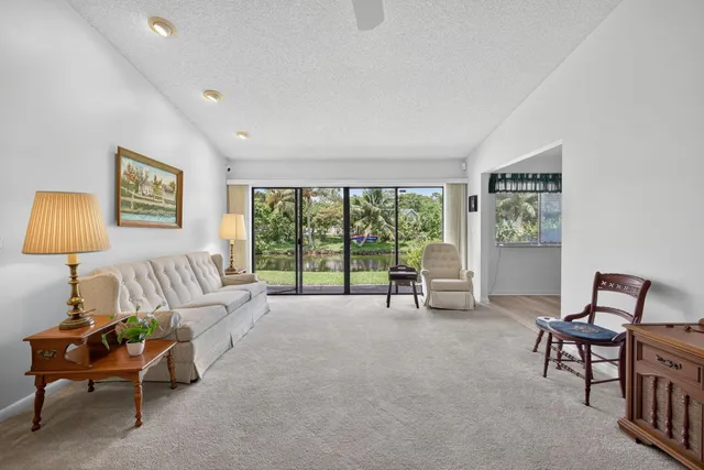 a living room with furniture and a floor to ceiling window