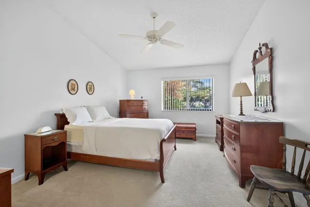 a spacious bedroom with a bed and a chandelier