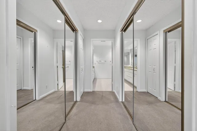 a bathroom with a tub shower vanity and a sink
