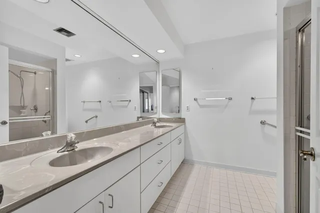 a bathroom with a glass shower door