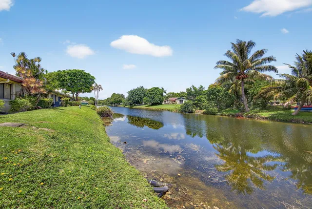 a view of a house with brick walls and a large tree