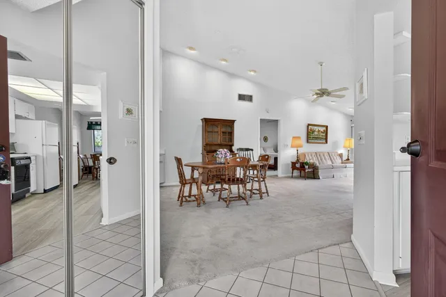 a view of a livingroom with furniture and a dining table