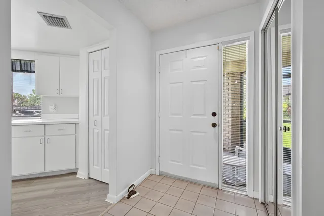 a kitchen with a sink window and cabinets