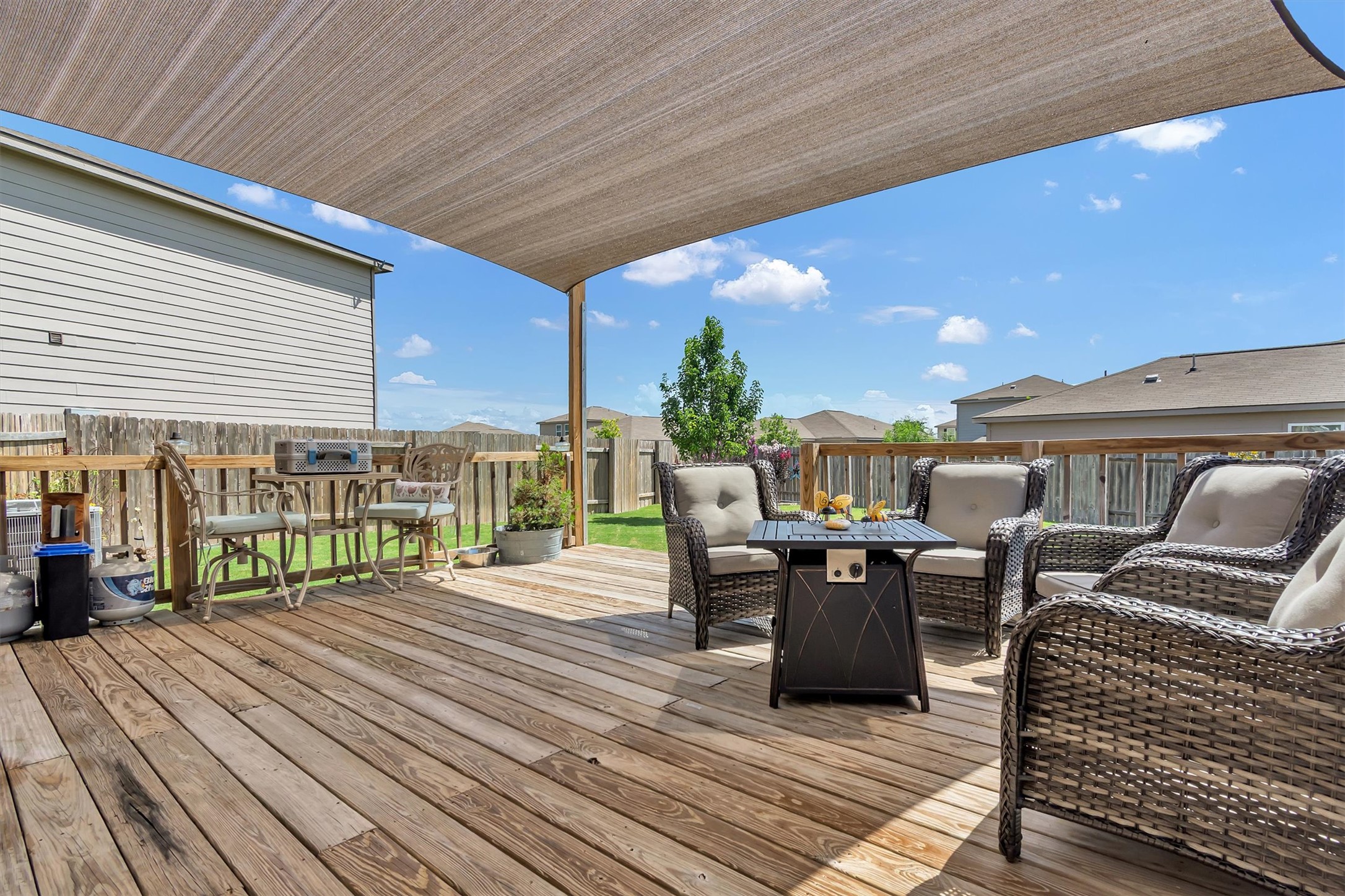 100 Wincliff Cove, Unit 13D Jarrell, TX 76537 - Photo 15 of 21 Enjoy Texas sunsets on this spacious wooden deck, shaded by a large awning, overlooking a private yard.