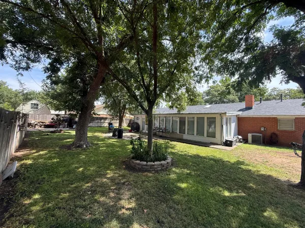 a view of a house with backyard and sitting area