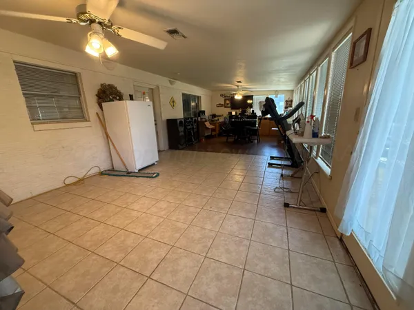 a view of a livingroom with furniture and a ceiling fan
