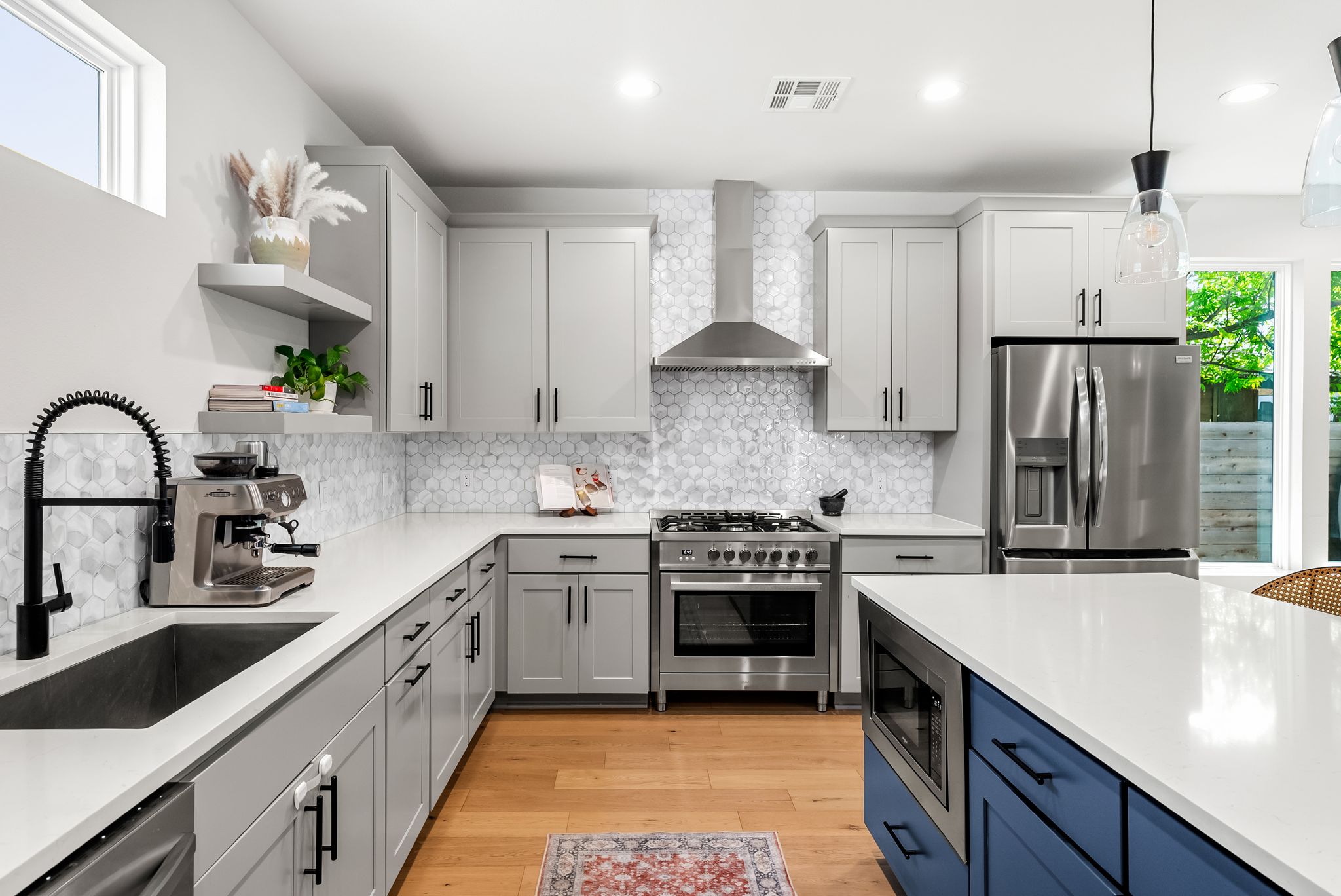 5109 Stone Gate Drive, Unit 1 Austin, TX 78721 - Photo 11 of 36 a kitchen with stainless steel appliances a sink stove and refrigerator