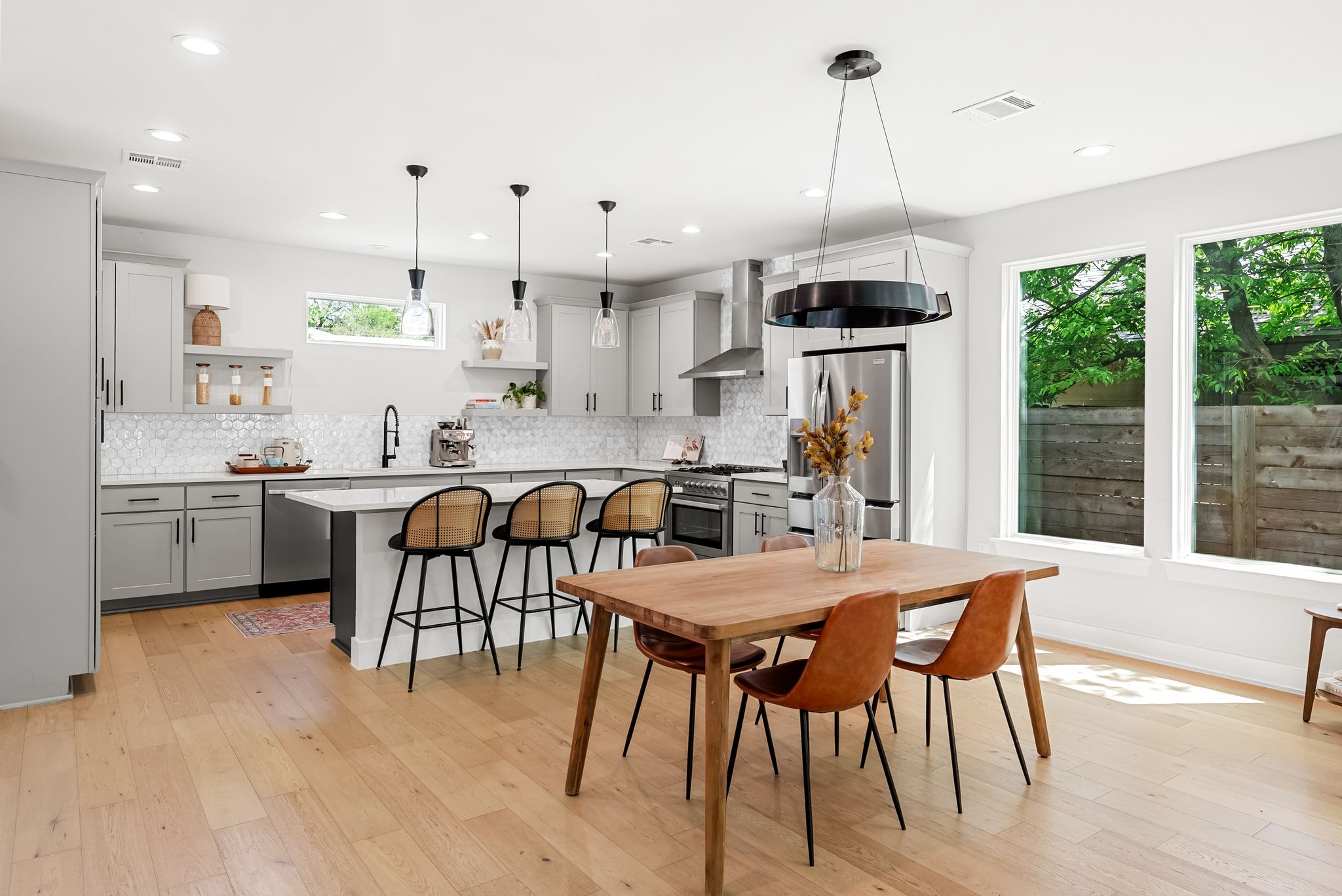 5109 Stone Gate Drive, Unit 1 Austin, TX 78721 - Photo 12 of 36 a kitchen with stainless steel appliances kitchen island granite countertop a sink and a refrigerator