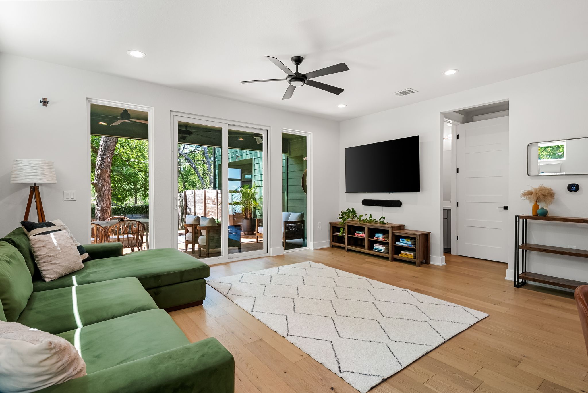 5109 Stone Gate Drive, Unit 1 Austin, TX 78721 - Photo 14 of 36 a living room with furniture and a flat screen tv