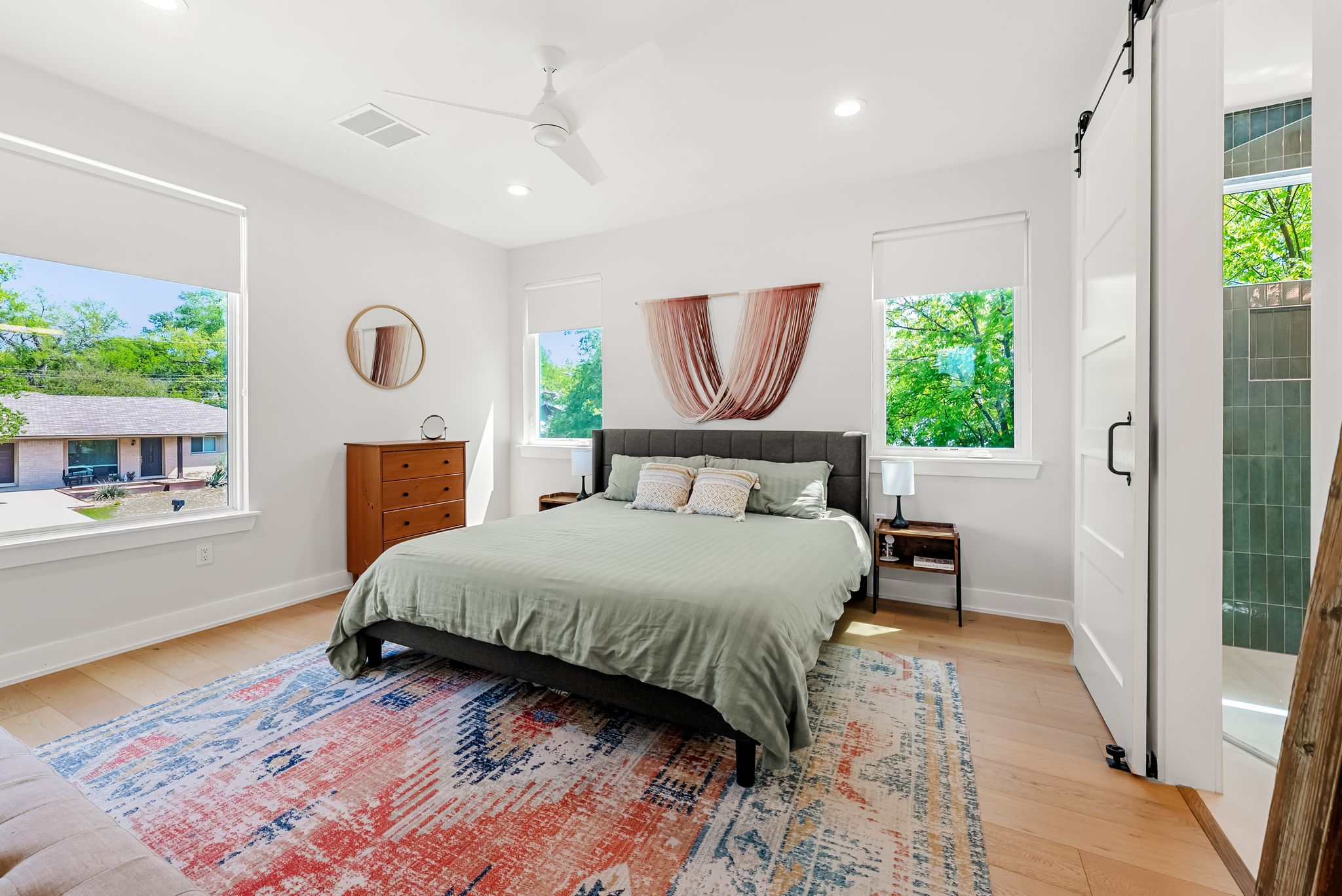 5109 Stone Gate Drive, Unit 1 Austin, TX 78721 - Photo 19 of 36 a bedroom with a bed a window and potted plant