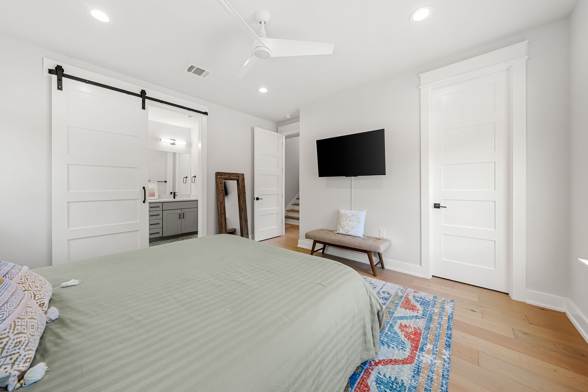 5109 Stone Gate Drive, Unit 1 Austin, TX 78721 - Photo 20 of 36 a bedroom with a bed and a flat screen tv