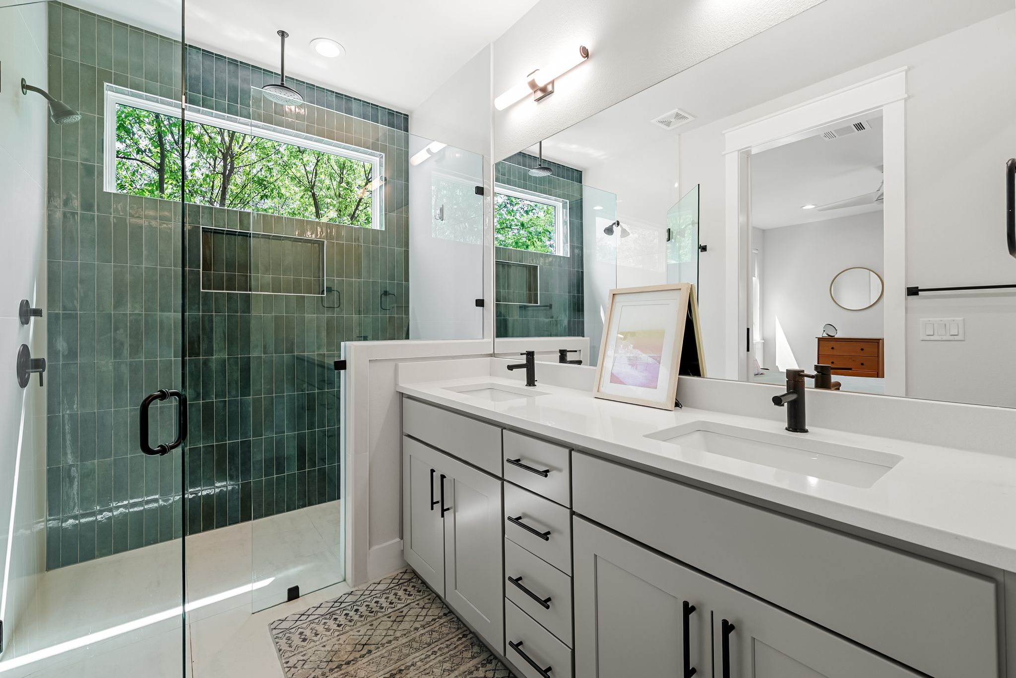 5109 Stone Gate Drive, Unit 1 Austin, TX 78721 - Photo 21 of 36 a bathroom with a shower sink and mirror