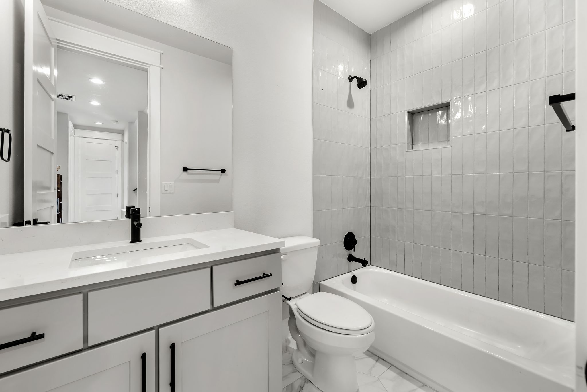 5109 Stone Gate Drive, Unit 1 Austin, TX 78721 - Photo 23 of 36 a bathroom with a sink a toilet and shower