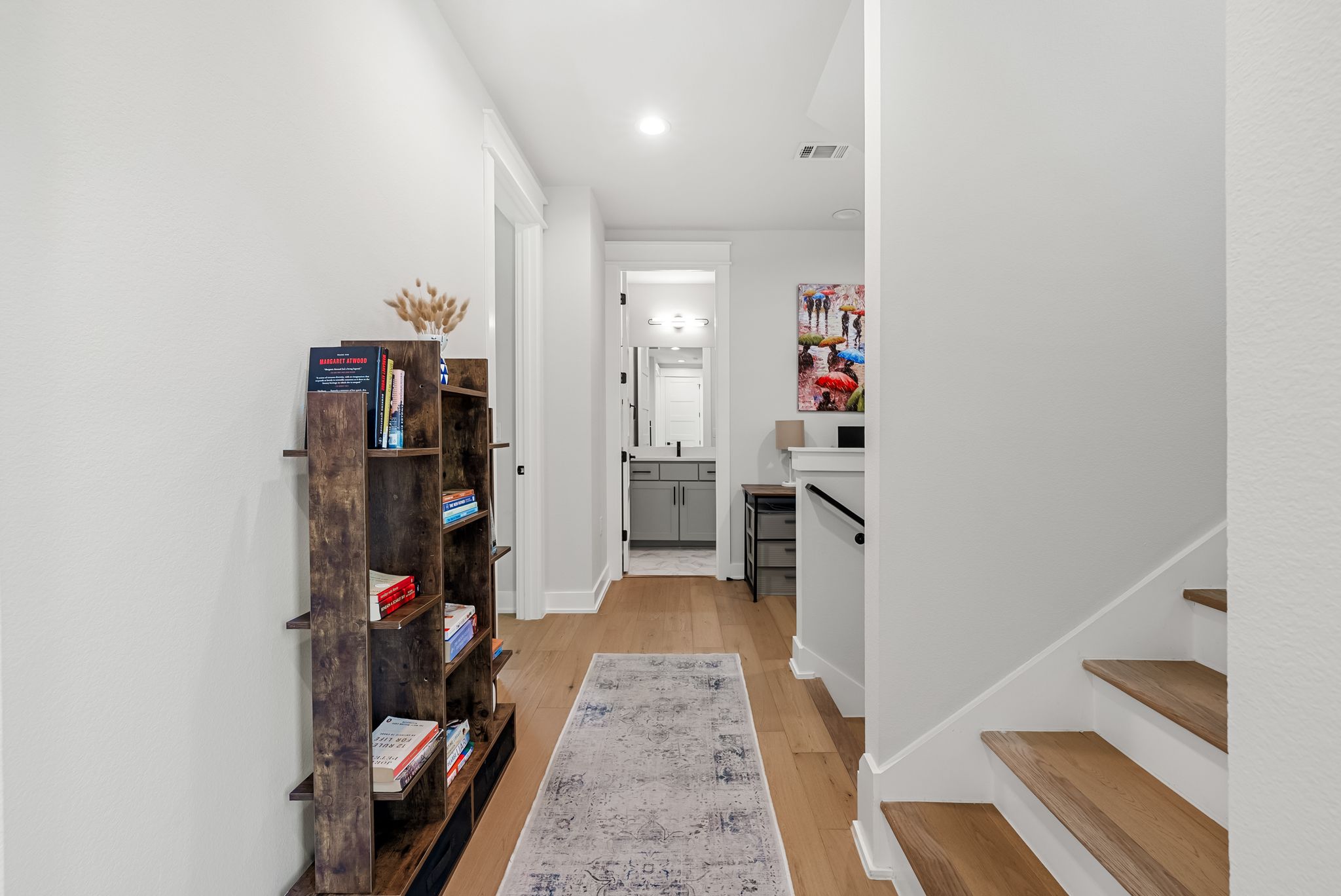 5109 Stone Gate Drive, Unit 1 Austin, TX 78721 - Photo 25 of 36 a view of a hallway with wooden floor and staircase