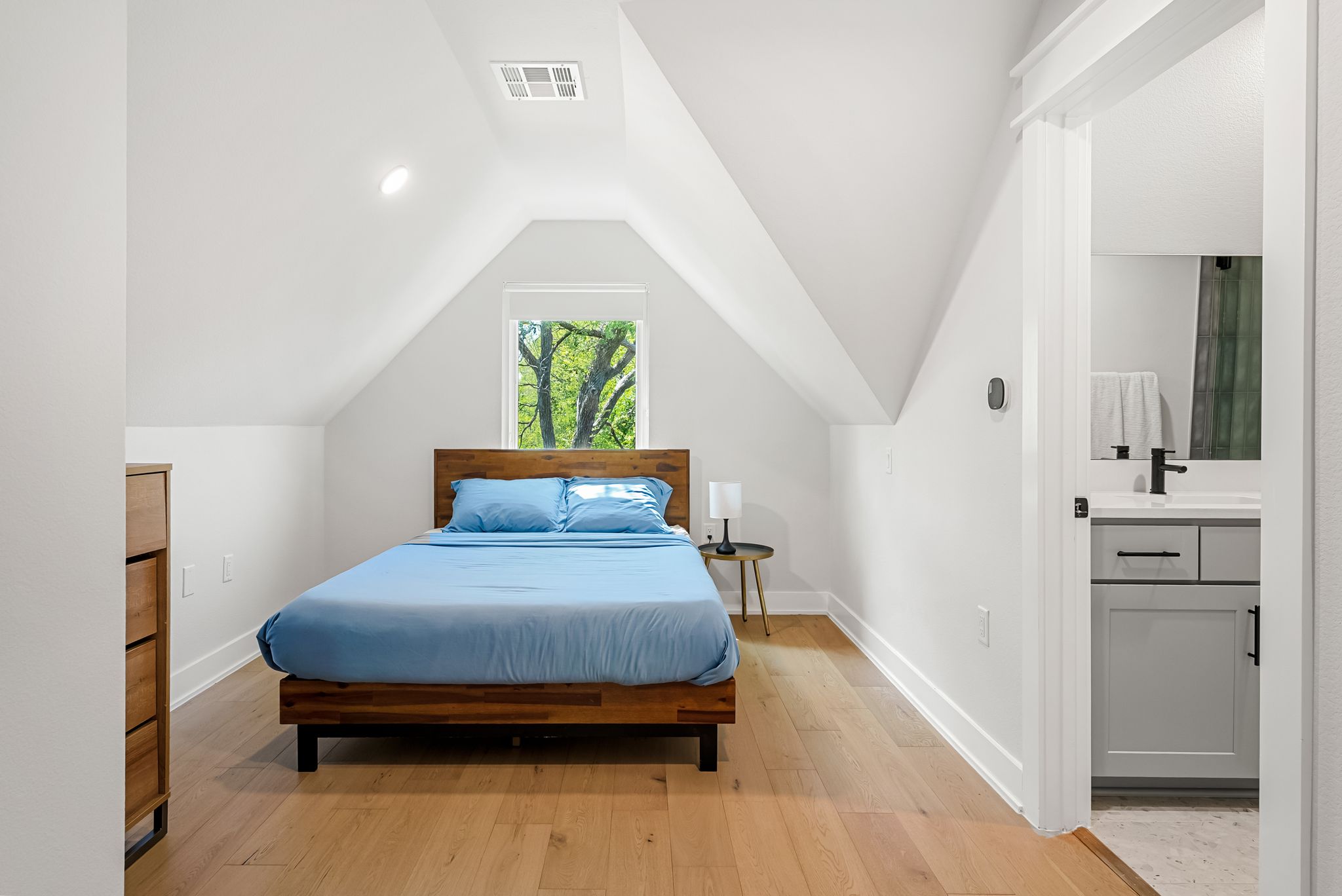 5109 Stone Gate Drive, Unit 1 Austin, TX 78721 - Photo 26 of 36 a bedroom with a bed and a dresser