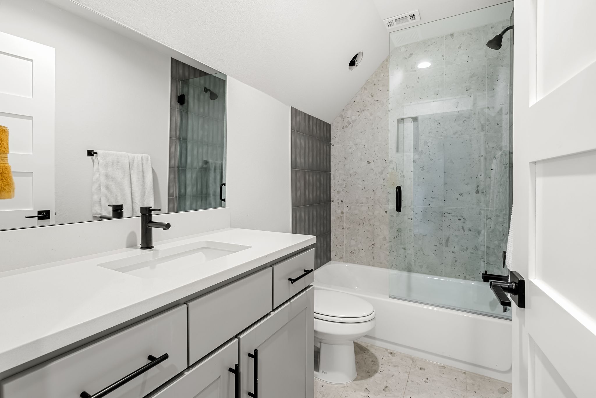 5109 Stone Gate Drive, Unit 1 Austin, TX 78721 - Photo 29 of 36 a bathroom with a sink a toilet and a bathtub