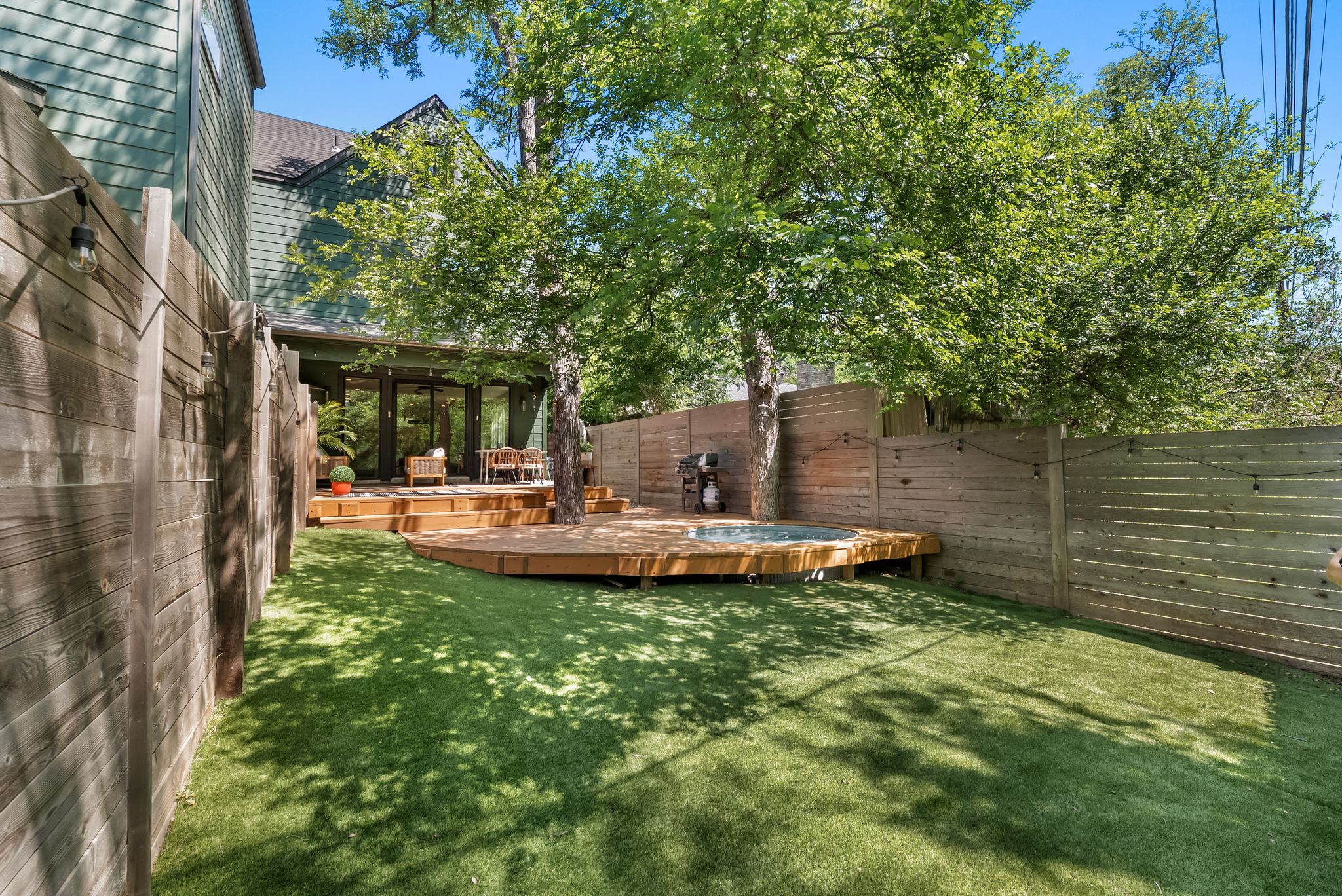 5109 Stone Gate Drive, Unit 1 Austin, TX 78721 - Photo 31 of 36 a view of a patio with table and chairs and potted plants