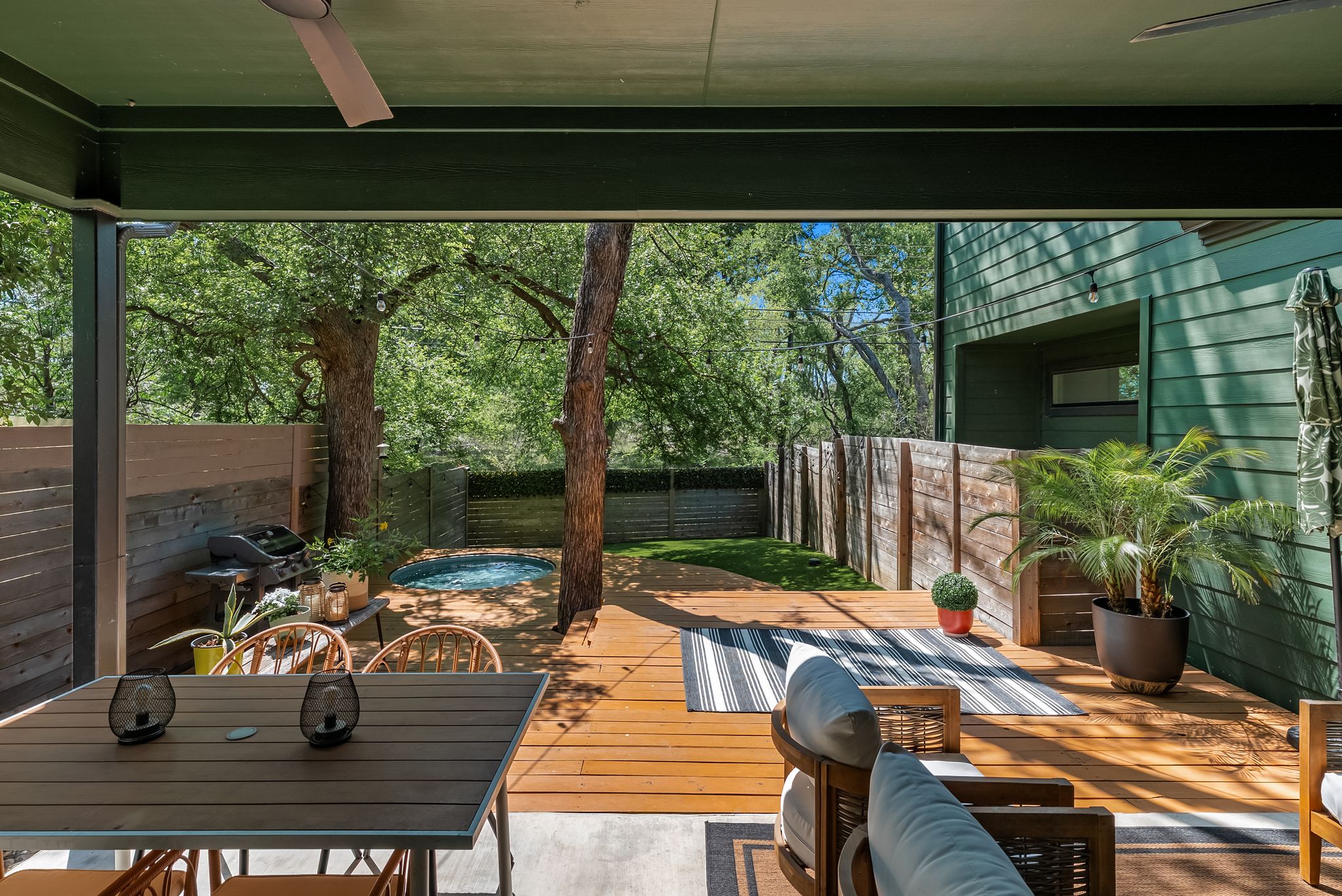 5109 Stone Gate Drive, Unit 1 Austin, TX 78721 - Photo 32 of 36 a view of a patio with table and chairs potted plants with floor to ceiling window