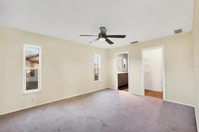 a view of a livingroom with a ceiling fan and window