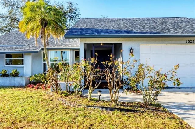 a view of front of house with potted plants