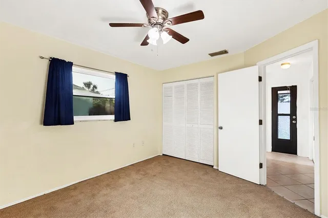 a bathroom with a granite countertop sink mirror vanity and toilet