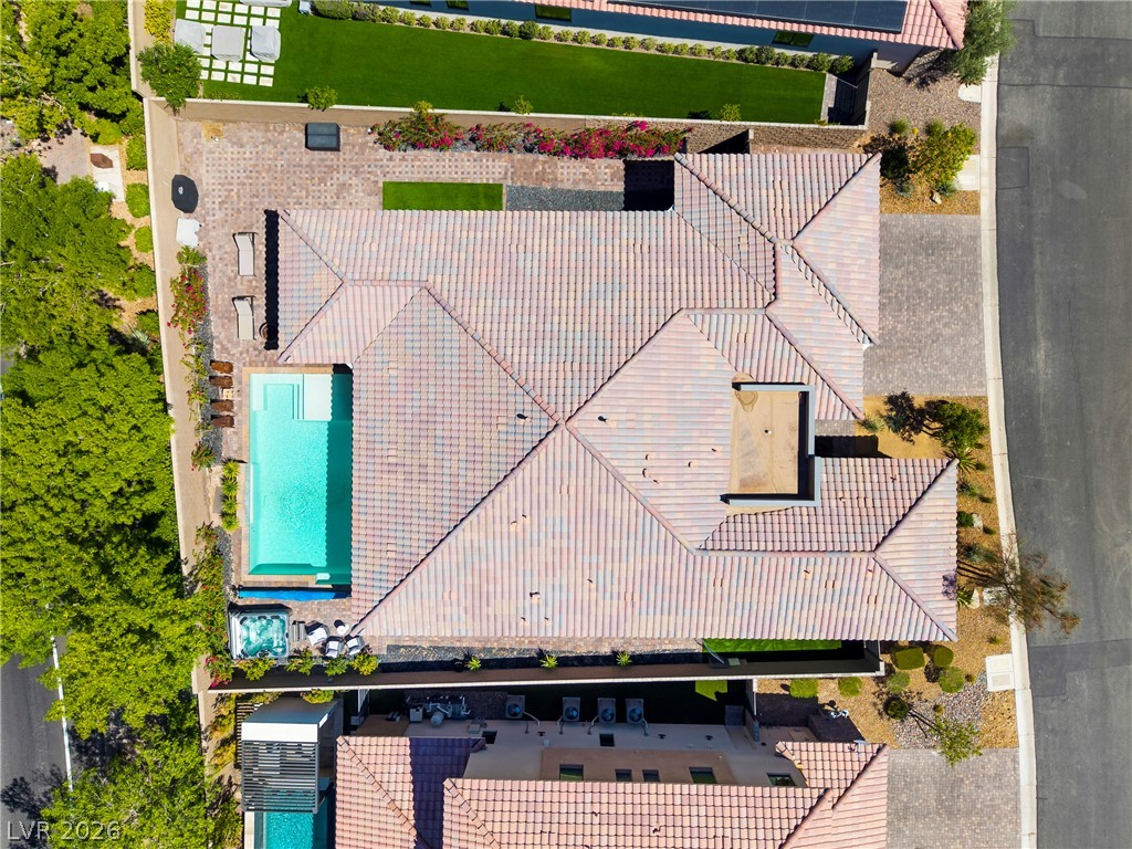 45 Garibaldi Way Henderson, NV 89011 - Photo 49 of 74 An aerial perspective reveals a luxurious backyard oasis with a pristine pool and lush landscaping.