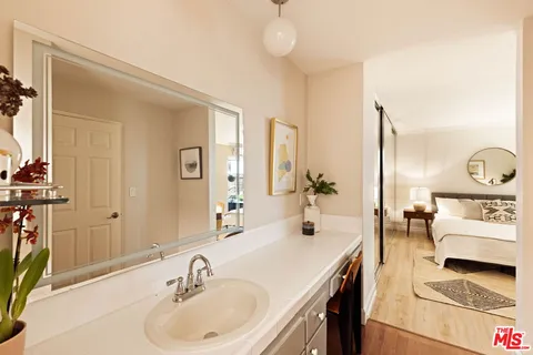 a en suite bathroom with a double vanity sink and a mirror