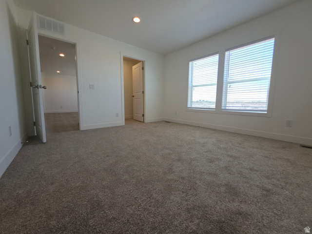 4640 West 5500 N Road Delta, UT 84624 - Photo 10 of 21 Carpeted room featuring two prominent windows with blinds, recessed lighting, and white trim