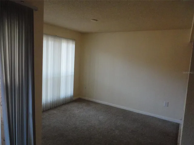 a view of an empty room and a window