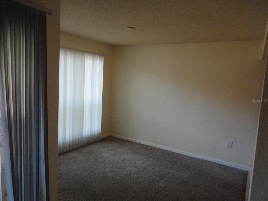 1810 Northwest 23rd Boulevard, Unit 207 Gainesville, FL 32605 - Photo 11 of 14 a view of an empty room and a window