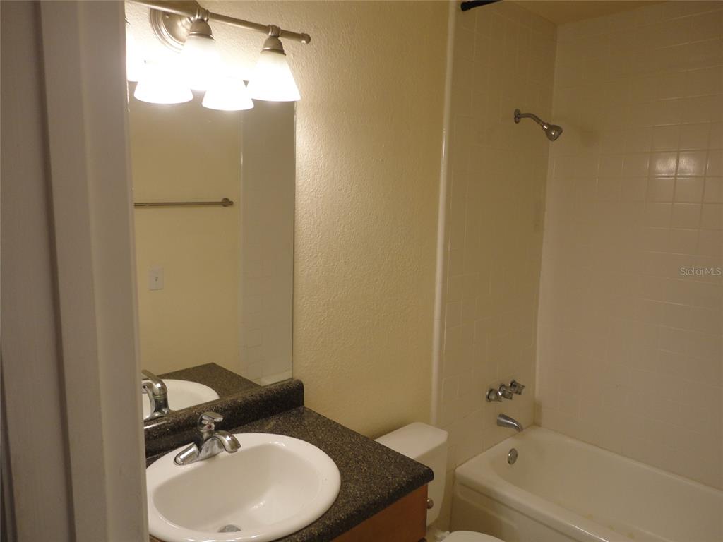 1810 Northwest 23rd Boulevard, Unit 207 Gainesville, FL 32605 - Photo 5 of 14 a bathroom with a sink toilet and shower