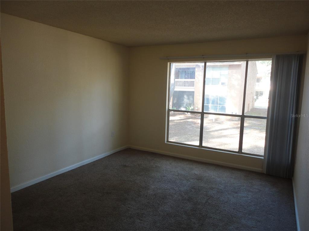 1810 Northwest 23rd Boulevard, Unit 207 Gainesville, FL 32605 - Photo 6 of 14 an empty room with a window