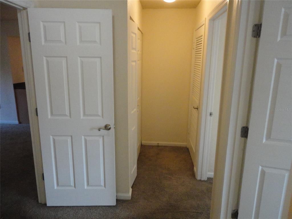 1810 Northwest 23rd Boulevard, Unit 207 Gainesville, FL 32605 - Photo 8 of 14 a view of a hallway with wooden floor