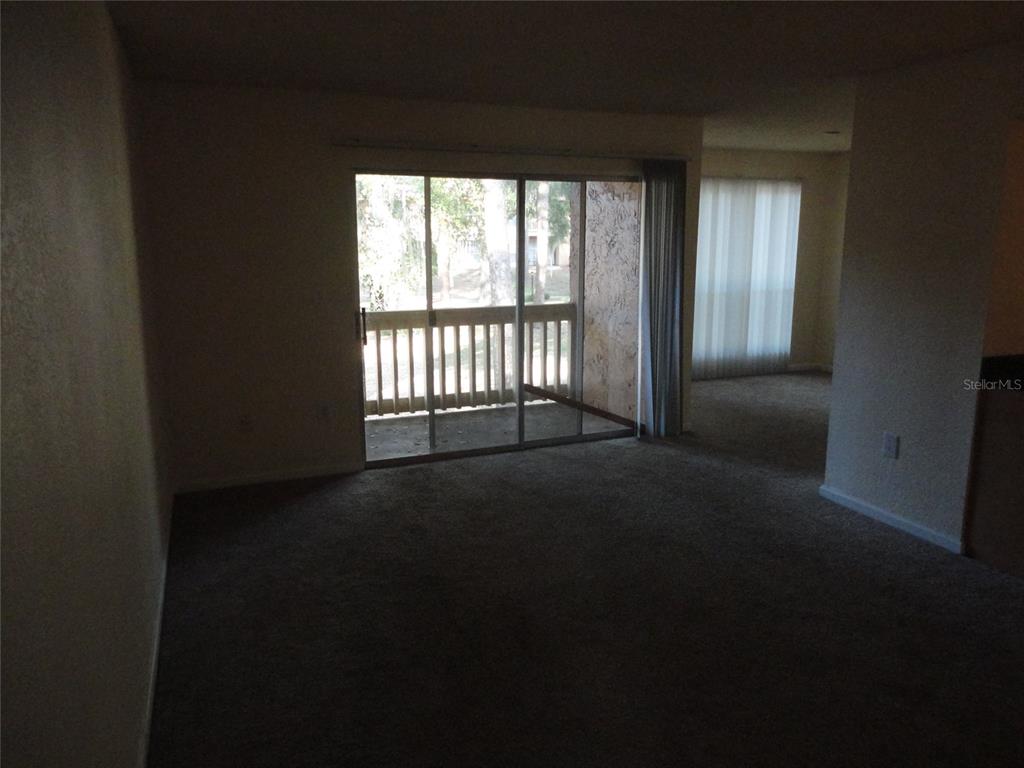 1810 Northwest 23rd Boulevard, Unit 207 Gainesville, FL 32605 - Photo 10 of 14 a view of empty room with floor and fan