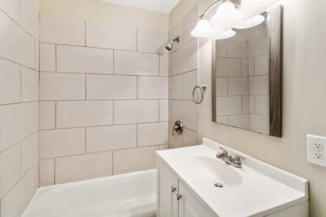 a bathroom with a sink shower and a bathtub