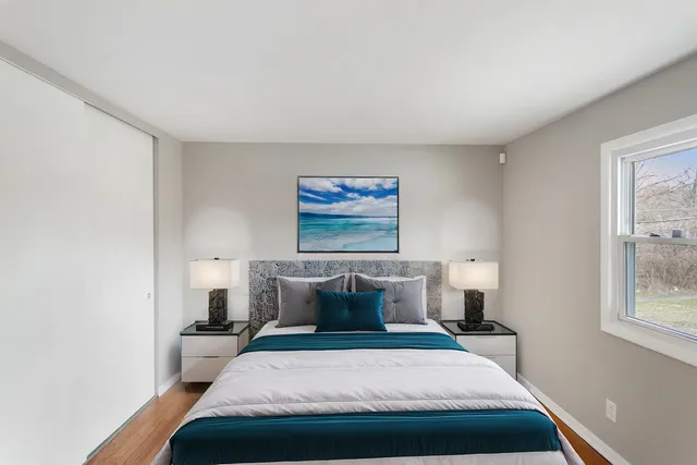 a bedroom with a bed and window