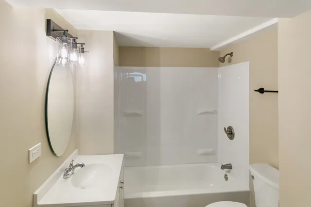 a bathroom with a shower and a sink