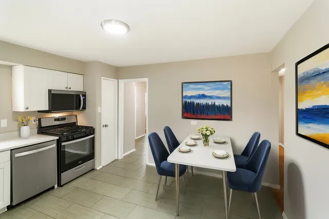a view of a dining room with furniture and a flat screen tv