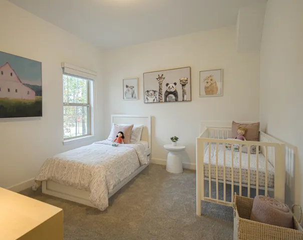 a large bed sitting in a bedroom next to a window