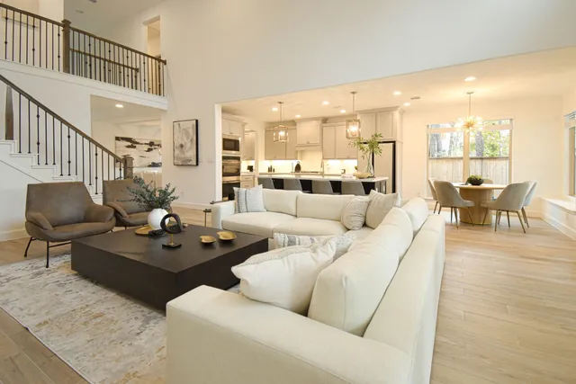a living room with furniture and kitchen view
