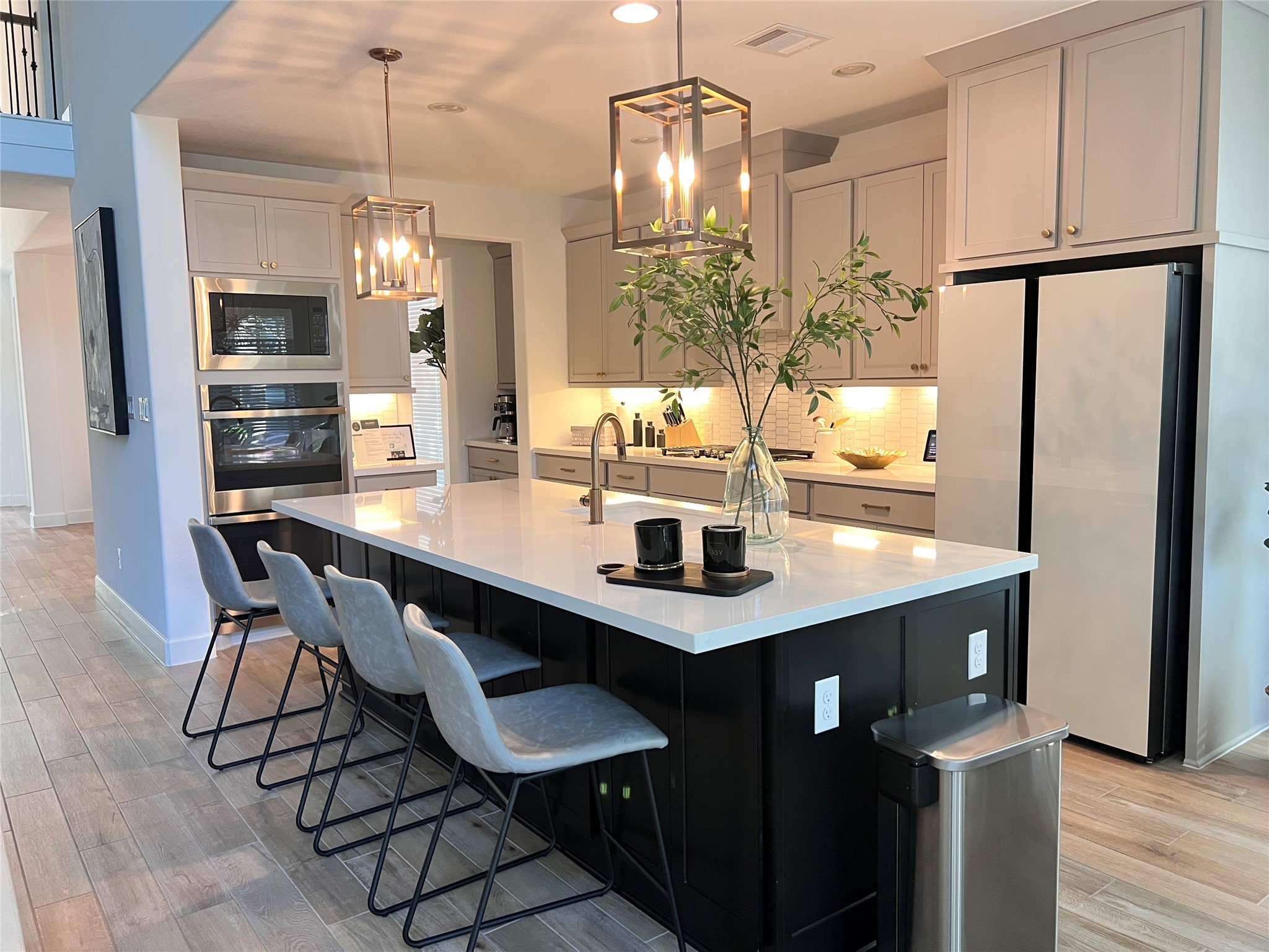 176 Sweeping Valley Drive Montgomery, TX 77316 - Photo 26 of 50 a kitchen with stainless steel appliances a dining table chairs refrigerator and cabinets