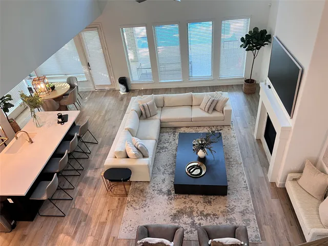 a view of a swimming pool with a patio and wooden fence
