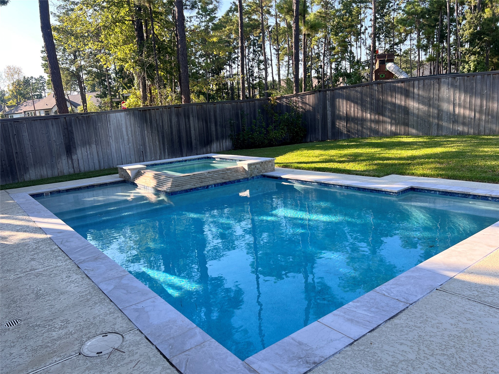 176 Sweeping Valley Drive Montgomery, TX 77316 - Photo 50 of 50 a view of a swimming pool with a patio and wooden fence